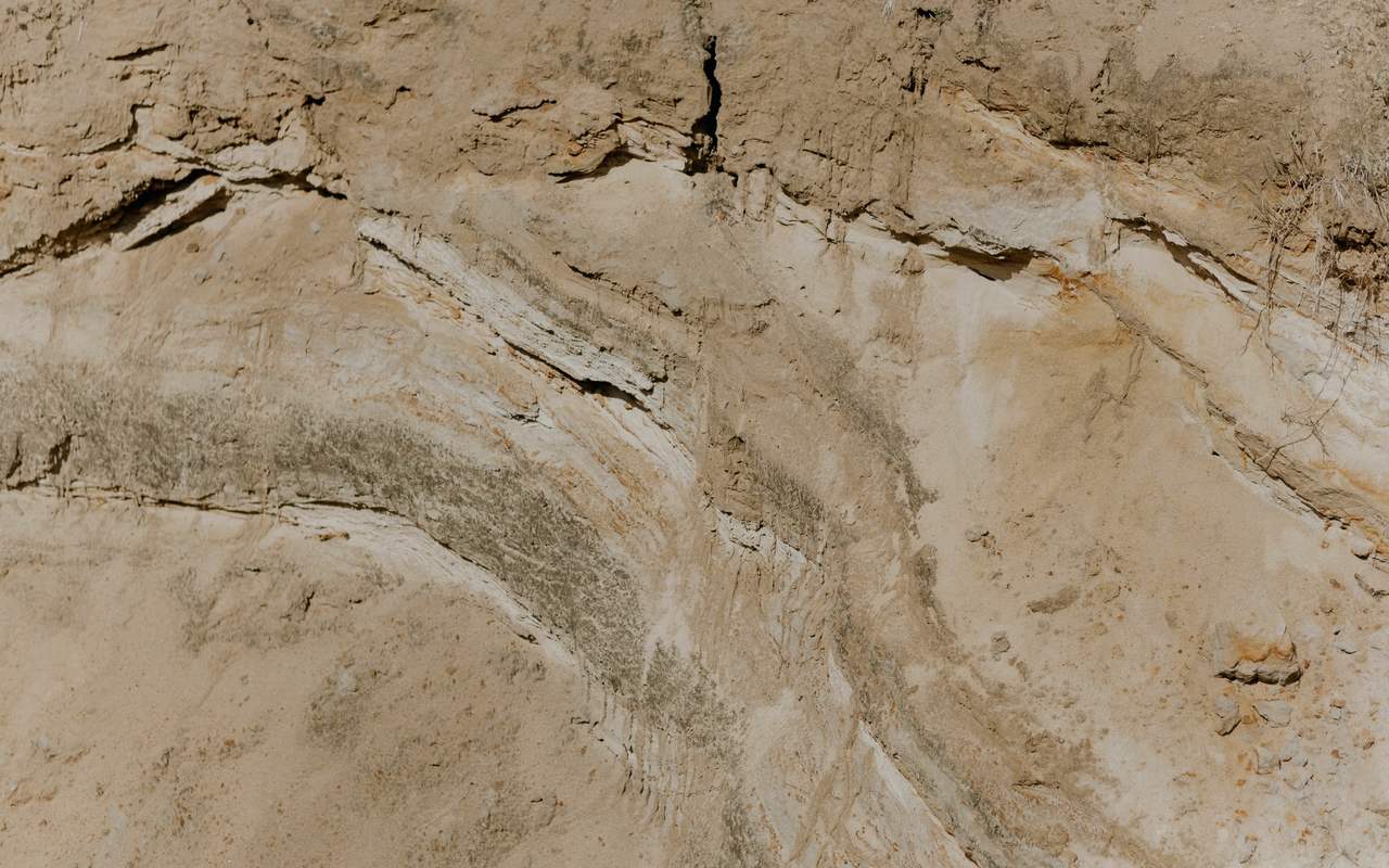 Dry and rugged cliff face showcasing nature's erosion patterns.